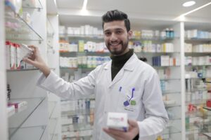 A pharmacist stocking medicines