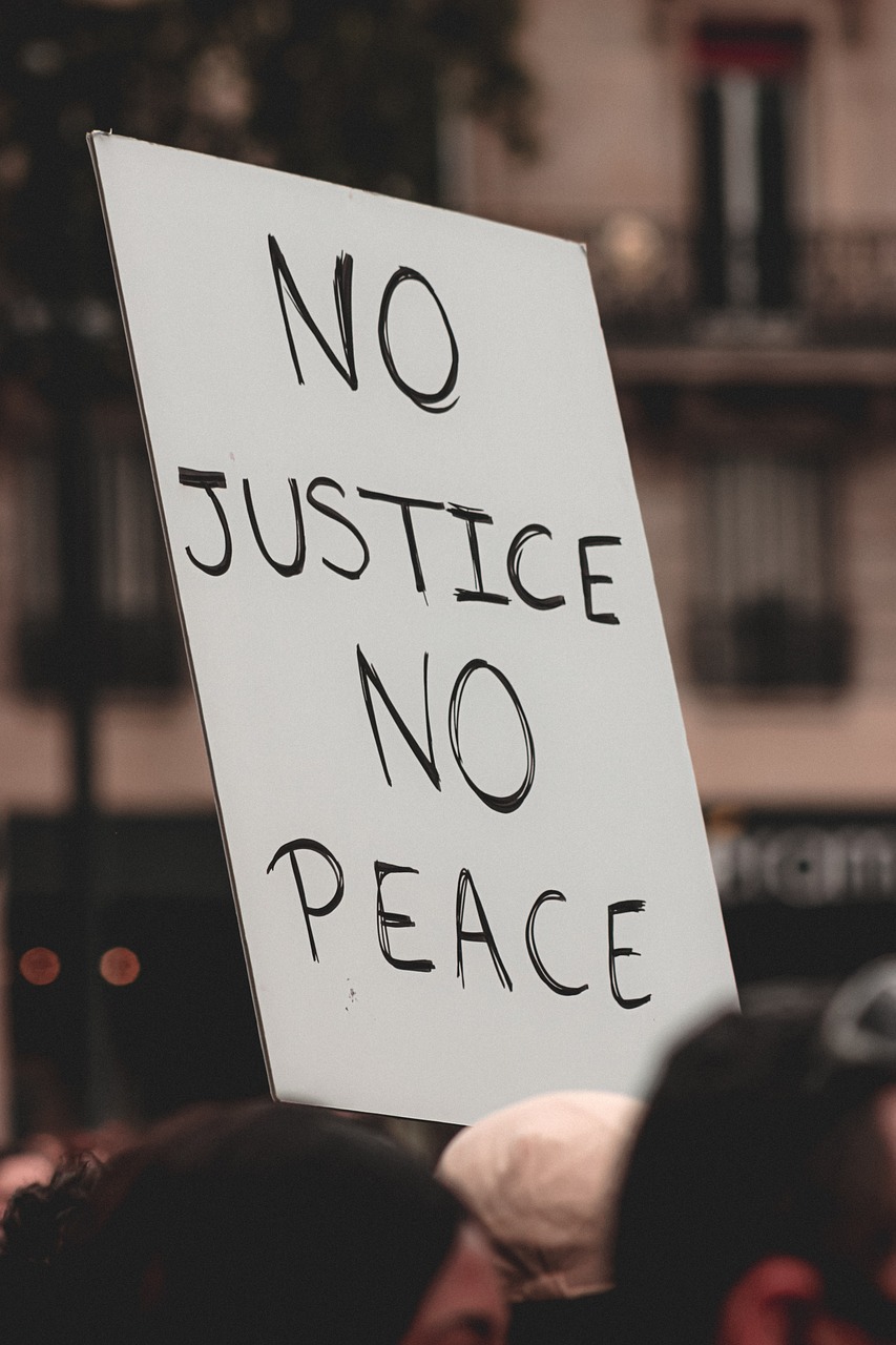 A placard with the phrase No Justice No Peace