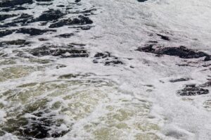 Water pollution swirling and foamy